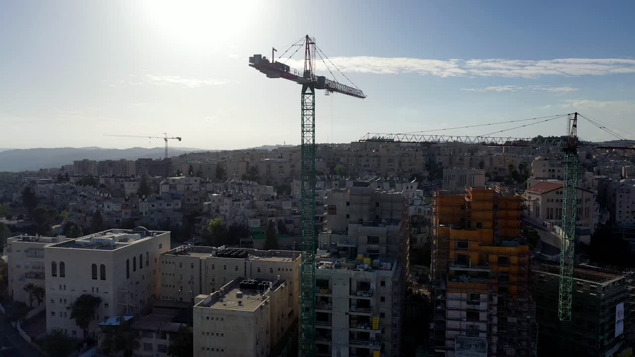 Construction in a Cityscape with Cranes