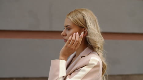 close up view of woman using wireless earphones