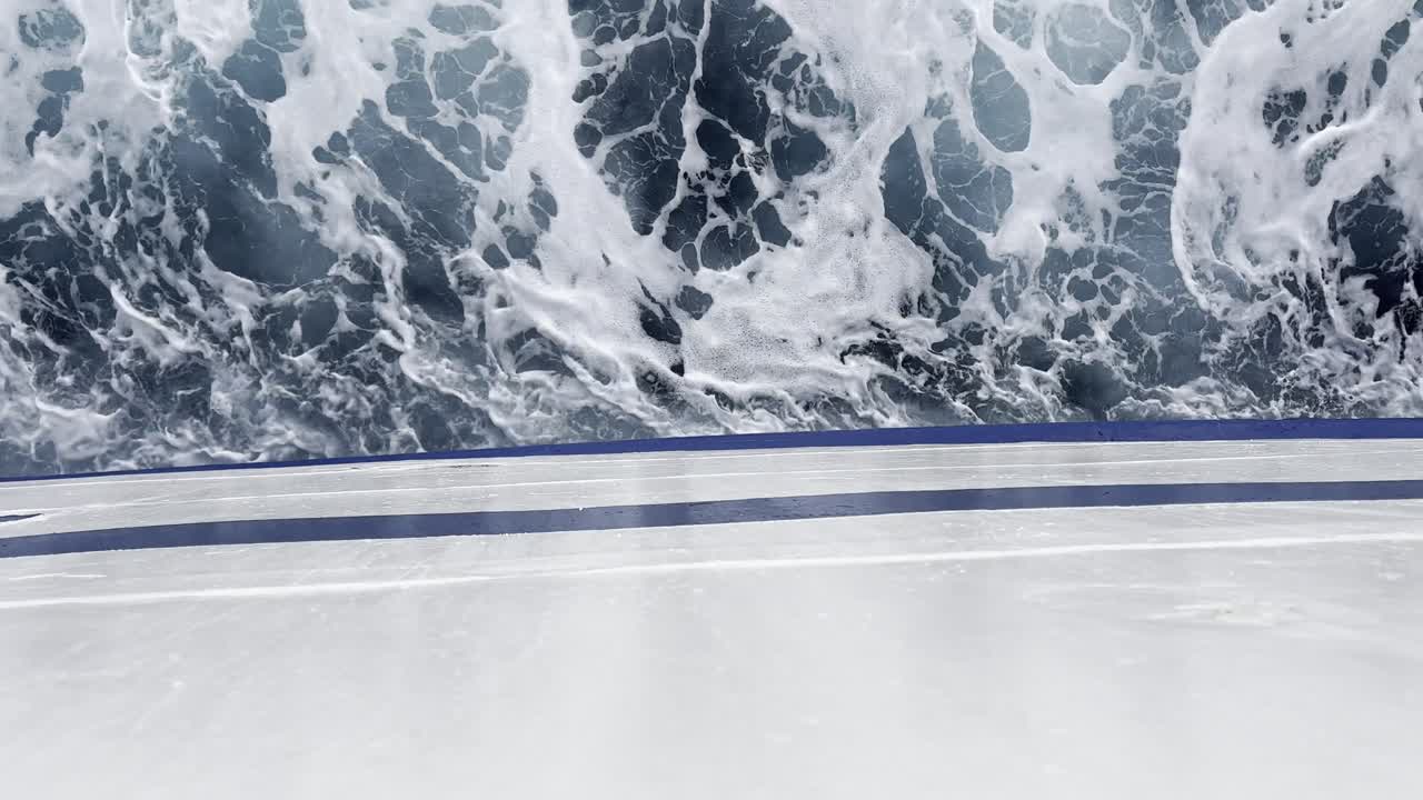 Overhead view from a moving boat’s deck, with the vessel and dynamic water forming a clean horizontal split