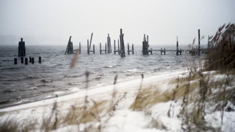 snow falls on a old wooden pier