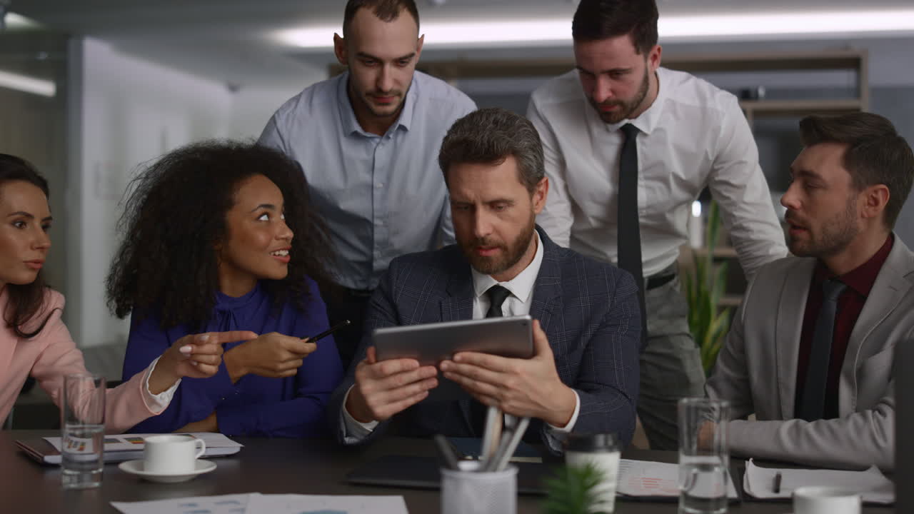Multiethnic executive team using a tablet