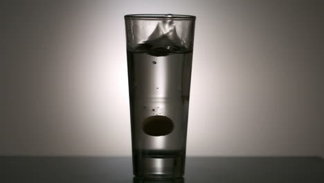 effervescent vitamin tablet in glass of water