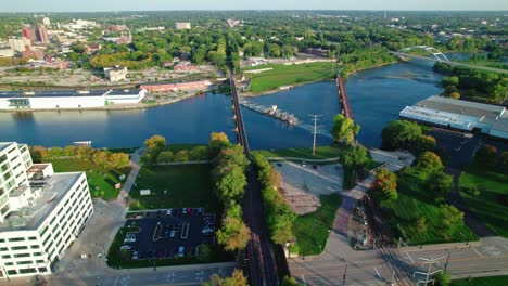 aerial shot the rock river crossing through rockford, illinois during sunset on a beautiful day