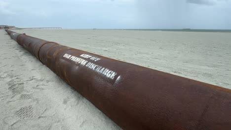 pipe pumping sand from ocean, beach replenishment, close up