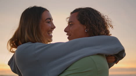 couple embracing at sunset beach