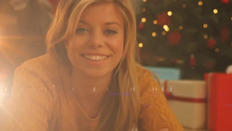 Animation-of-smiling-caucasian-woman-and-christmas-tree-with-flickering-fairy-lights