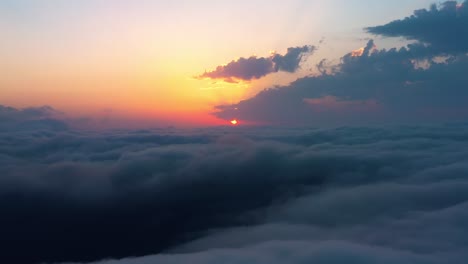 flying over the clouds with the late sun. sunrise or sunset colorful sky background.