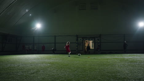 young female soccer player practicing indoors