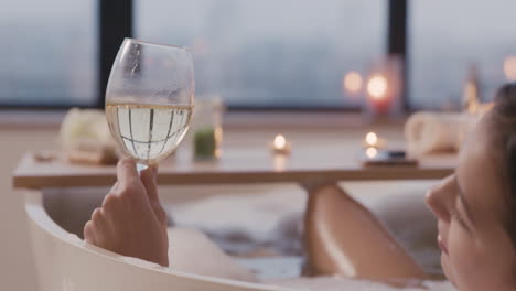 Camera-Focuses-On-A-Woman-Holding-A-Glass-Of-Wine-And-Drinking-1