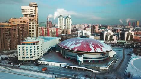 vista aérea de una ciudad con una arena de cúpula en invierno