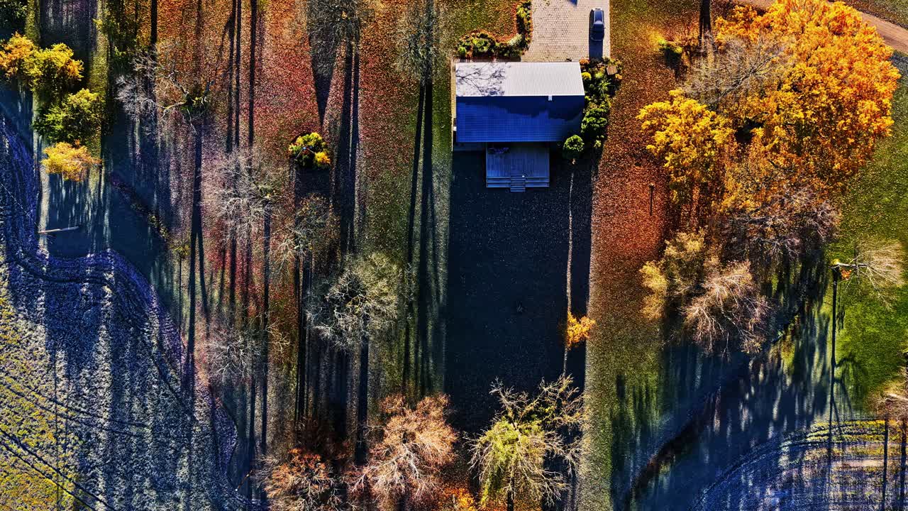 Time lapse of farm house in the countryside at sunset. Aerial top down view