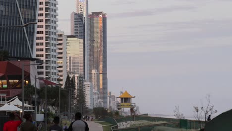 people walking in park with city skyline backdrop