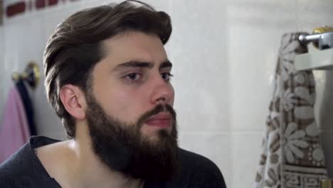 young man looking in a bathroom mirror