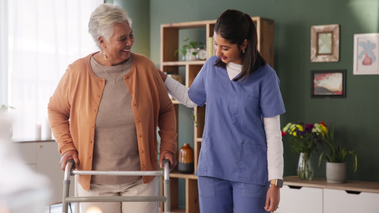 Caregiver assisting elderly woman with walker at home