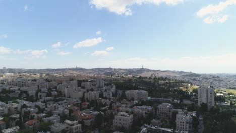 aerial fly over jerusalem with villages and settlements view. showing the wonder of co-existing living in cityscape with famous landmark against blue sky