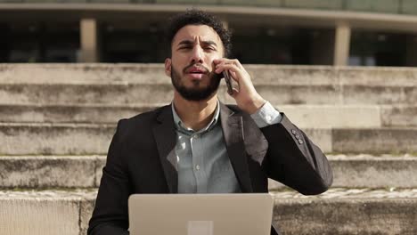 Focused-middle-eastern-businessman-working-outdoor