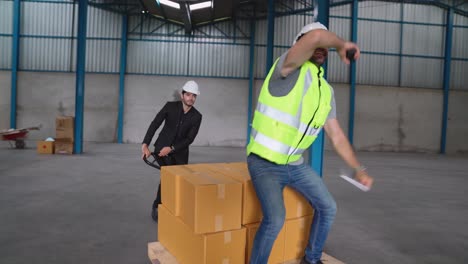 Funny factory workers dance in the factory