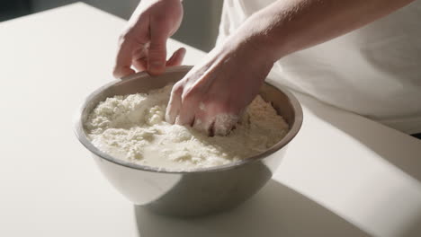 mixing flour and water by hand to make dough for bread or pizza dough 4k