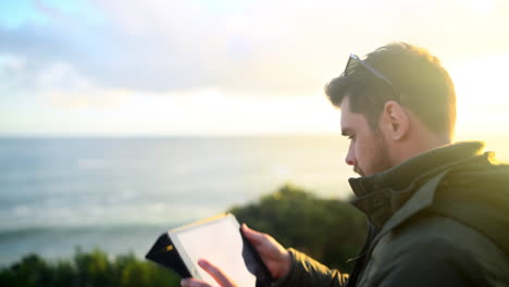 a young man using a tablet to take a picture