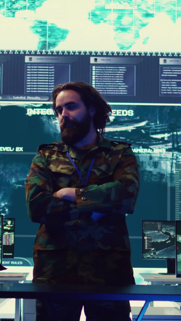 Bearded Man in Camouflage Jacket in High-Tech Control Room