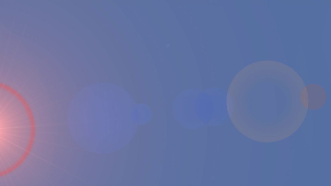 Blue gradient filling, red flare, bokeh appearing, trees emerging with snow drifting creating haze