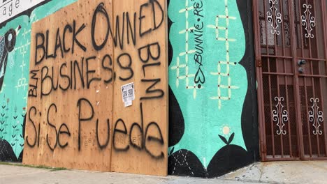 a boarded up los angeles storefront is identified as a black owned business during rioting and looting black lives matter protests  2