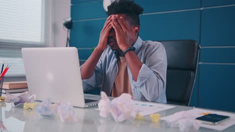 overworked african american businessman feeling headache or eye strain problem