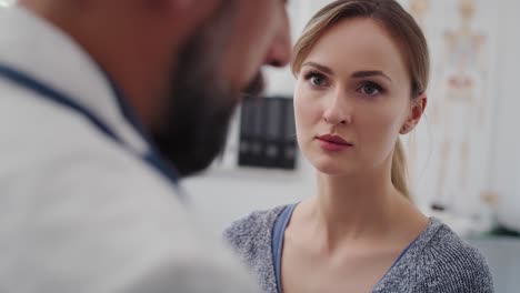 handheld view of doctor examining young woman