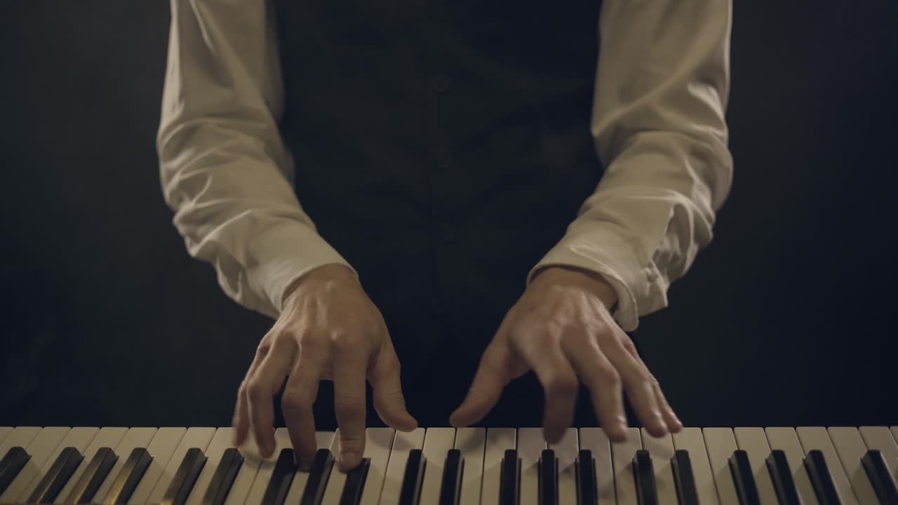male piano player in a suit playing a smoking piano 4k,