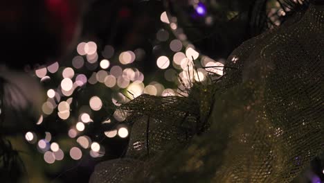 Glowing-Christmas-Lights,-Out-of-Focus-Blinking-With-Ribbon-Decoration-and-Ornaments,-Abstract,-Background