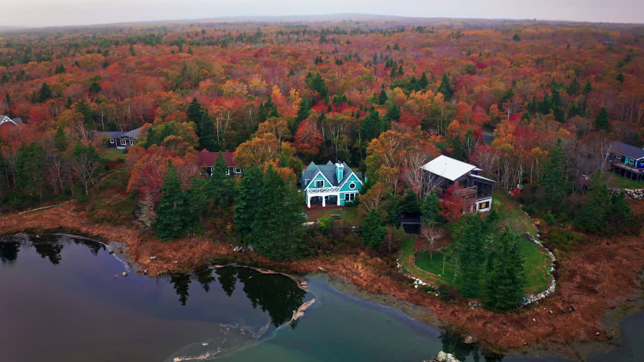 Autumn forest colors. Aerial drone shot over the picturesque landscape of Whitepoint in Nova Scotia, Canada.
Bird's eye view of the colorful foliage and the lake. Vibrant tree leaves. Fall landscape.