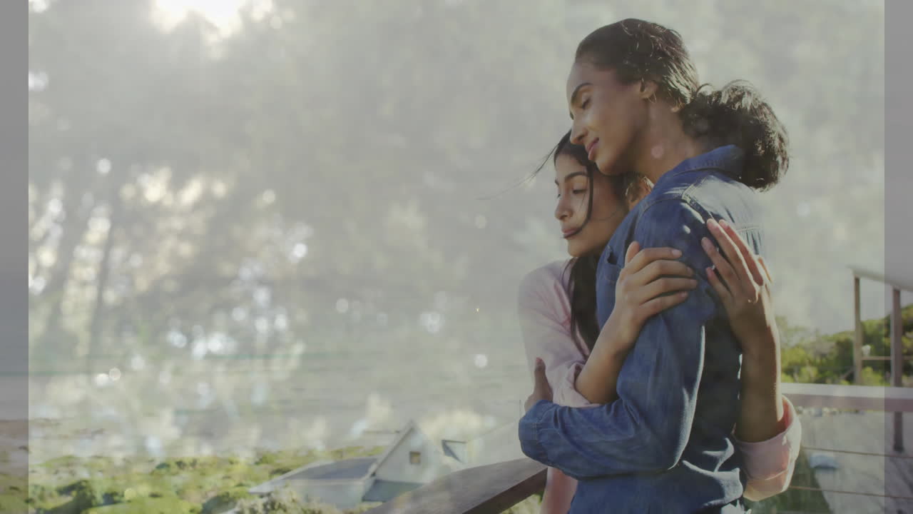 Embracing on balcony, two women gazing at scenic landscape animation