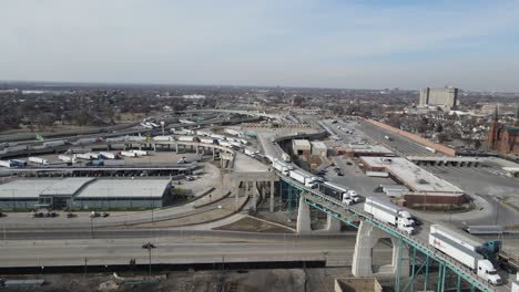 Convoy-of-trucks-slowly-driving-over-Ambassador-bridge-to-cross-USA---Canada-border