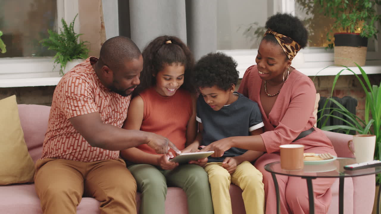 Afro Family Playing Games On Tablet Together