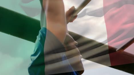 animation of flag go italy over strong muscular man doing pull ups
