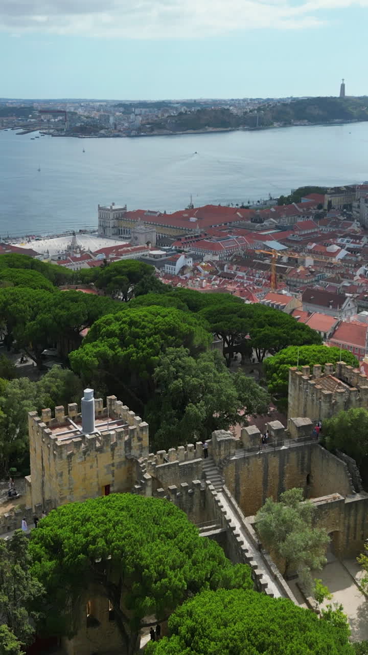 Vertical drone shot backwards over the São jorge Castle, sunny day in Lisbon