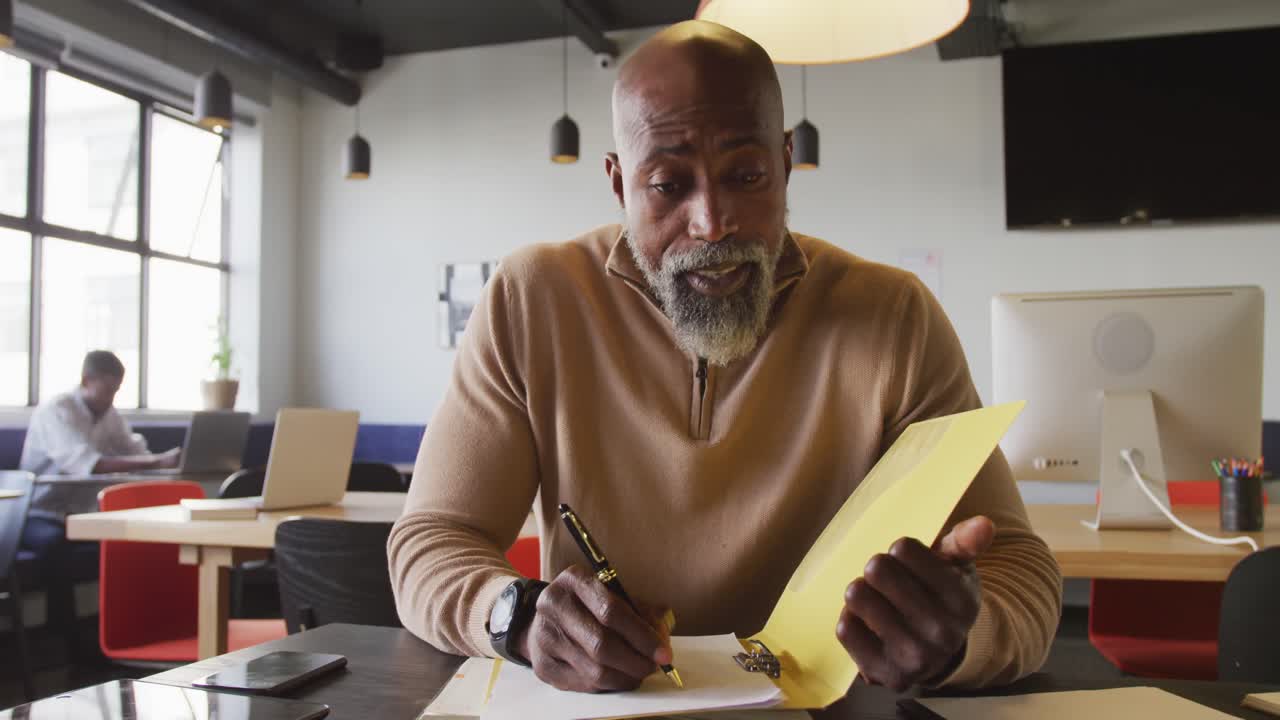 Portrait of african american businessman looking at camera at office