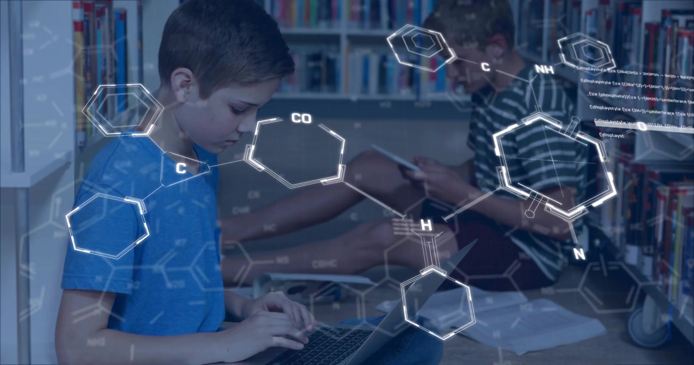 Two boys studying in library one typing initiating chemical graphics other reading aiding education