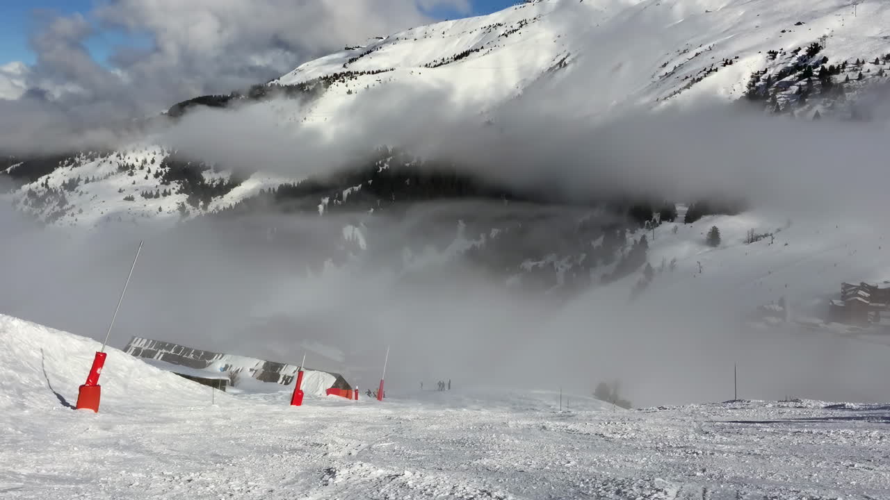 People skiing on the mountains at a ski resort in Les Belleville, France