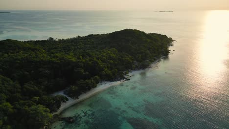 reverse-dolly-aerial-view-of-Tanjung-Gelam-or-Sunset-Beach-during-sunset-time,-Karimunjawa,-Central-Java---Indonesia