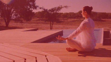 meditating on wooden deck, person in white over red-tinted animation