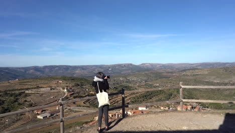 traveler making a panoramic view of the views with her camera