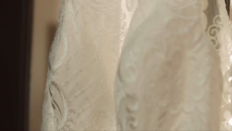 hanging wedding dress on door gimbal shot