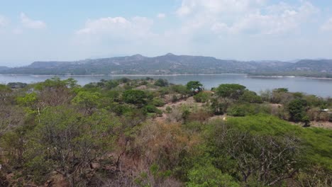 Flyover-hilly-landscape-toward-Cerron-Grande-Reservoir,-El-Salvador