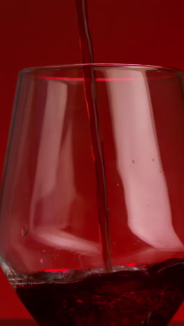 pouring red wine into a wine glass