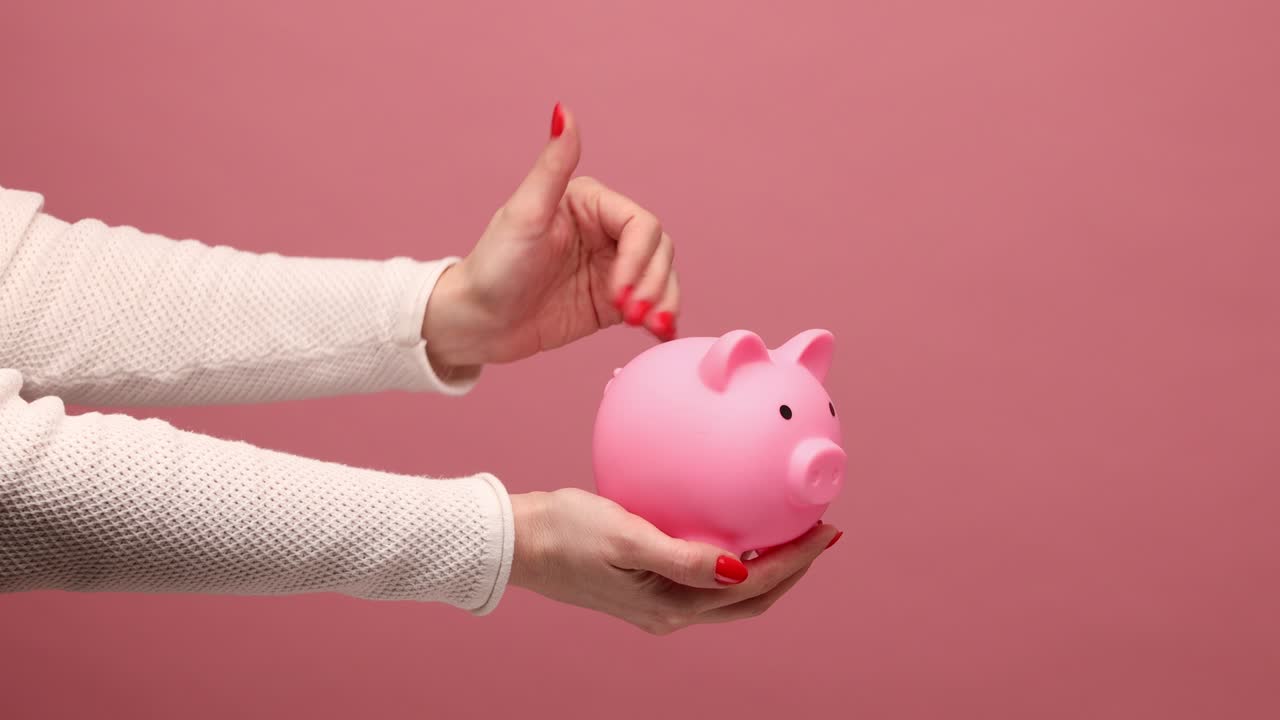Woman hand puuting dollar banknote into piggy bank, investment, saving money.