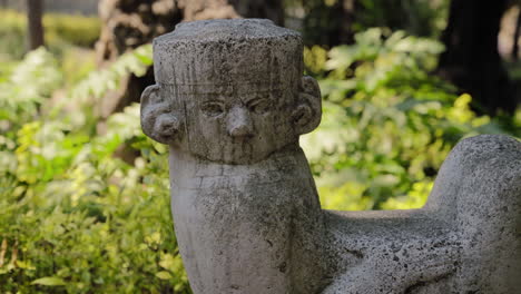 stone statue with aged surface and hand carvings