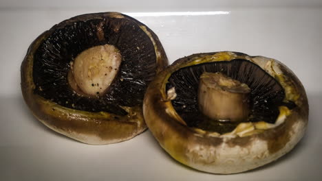 flat field mushrooms roasted in olive oil in the oven, captured by time-lapse