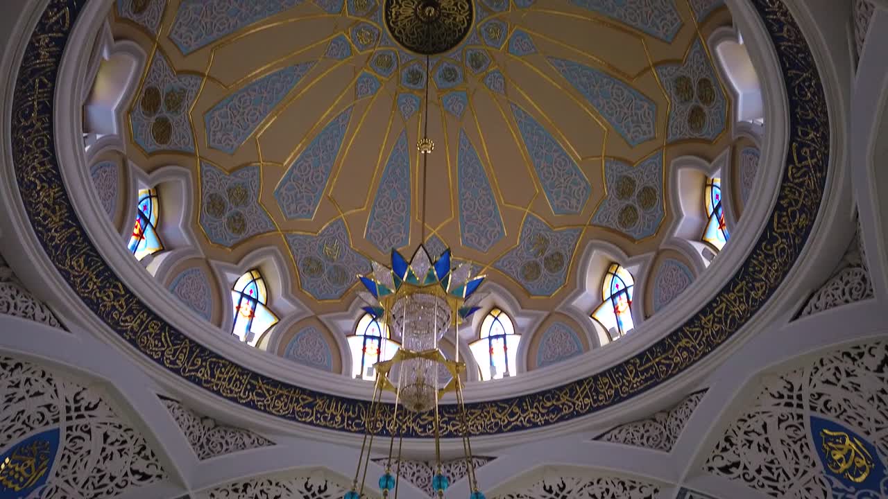 Pan shot inside of Qol Sarif Mosque reavealing huge and beautiful chandelier. Camera motion shot.