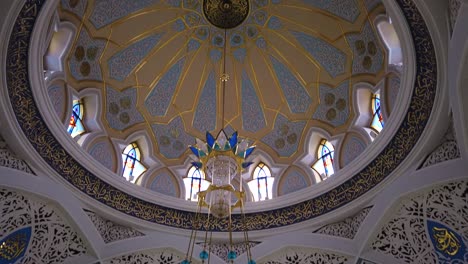 pan shot inside of qol sarif mosque reavealing huge and beautiful chandelier. camera motion shot.